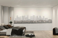 The color palette is composed of muted grays, soft blues, and subtle, diffused lights from the city.
