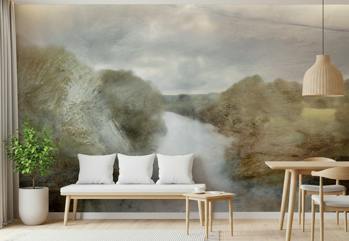 River Haze wallpaper mural of a misty river between olive hills behind a wood bench with white pillows in a living room