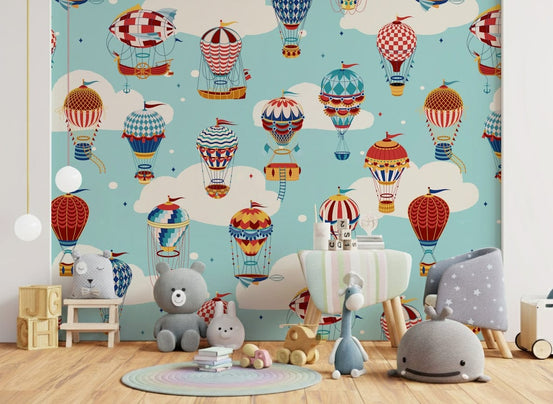 Up, Up, and Away! wallpaper mural with vintage hot air balloons in a kids playroom with teddy bears and a gray armchair