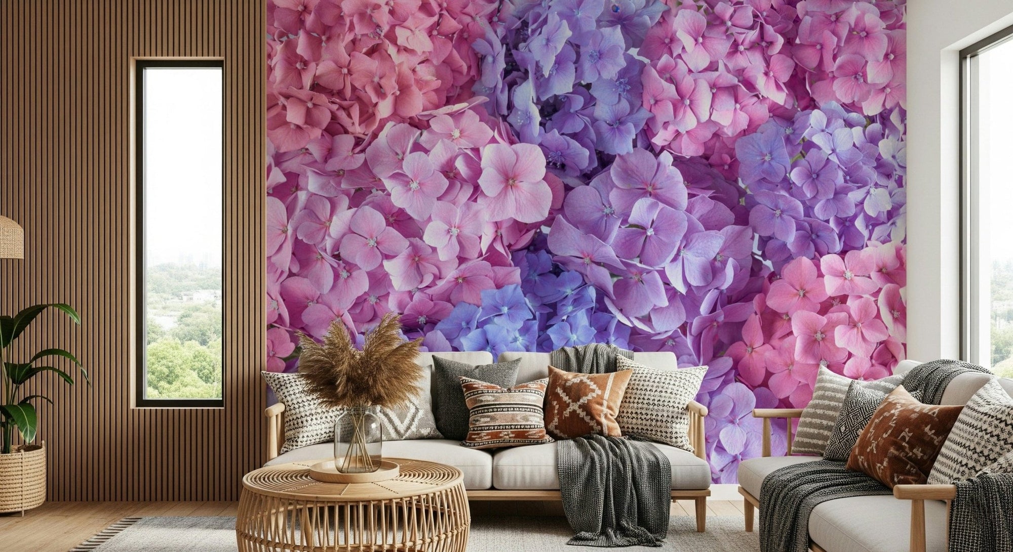 Hydrangea Hues wallpaper mural of pink and purple hydrangea blooms in a living room with a white sofa and boho pillows