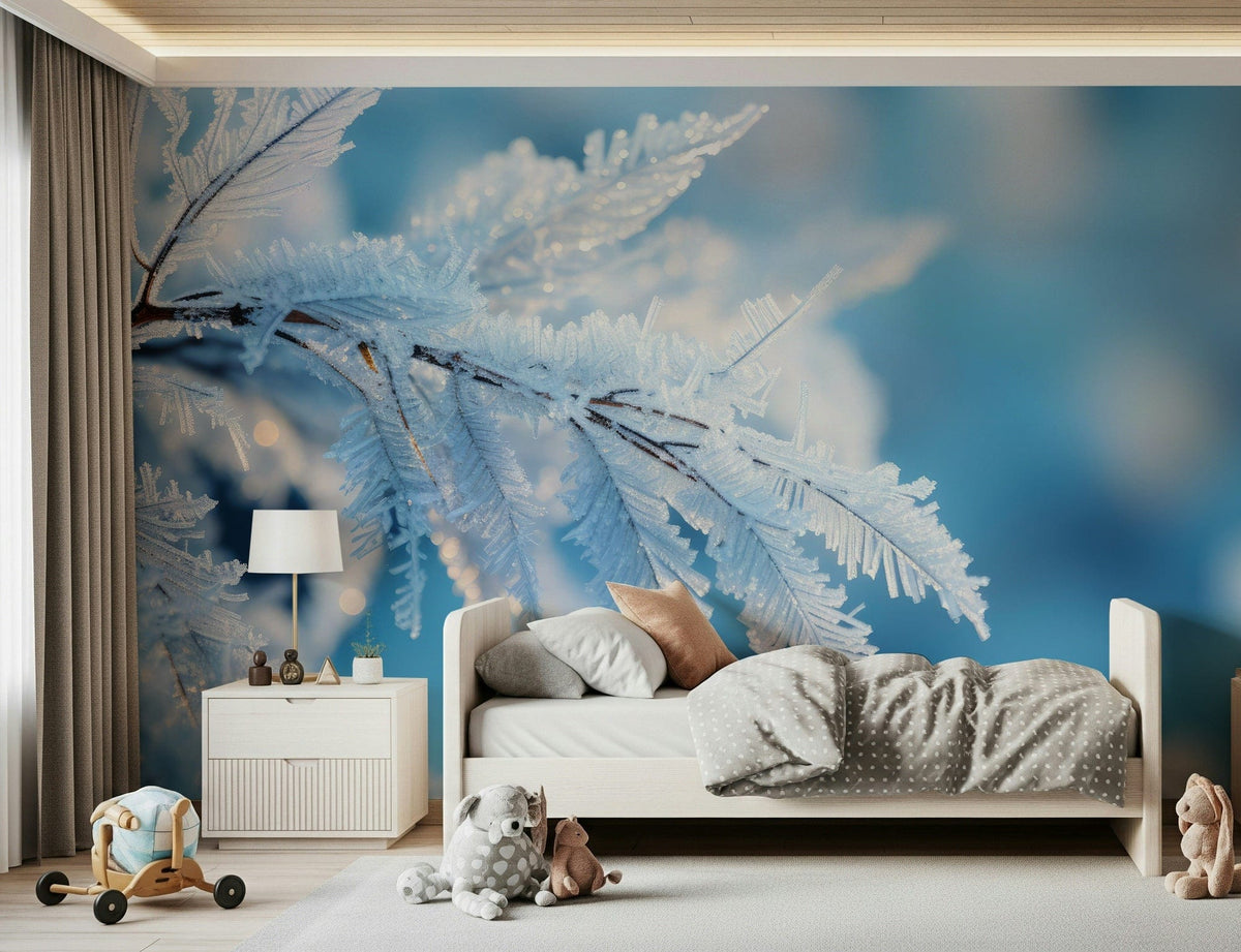 Icy Fronds wallpaper mural of frost-covered branches on blue behind a white toddler bed in a nursery
