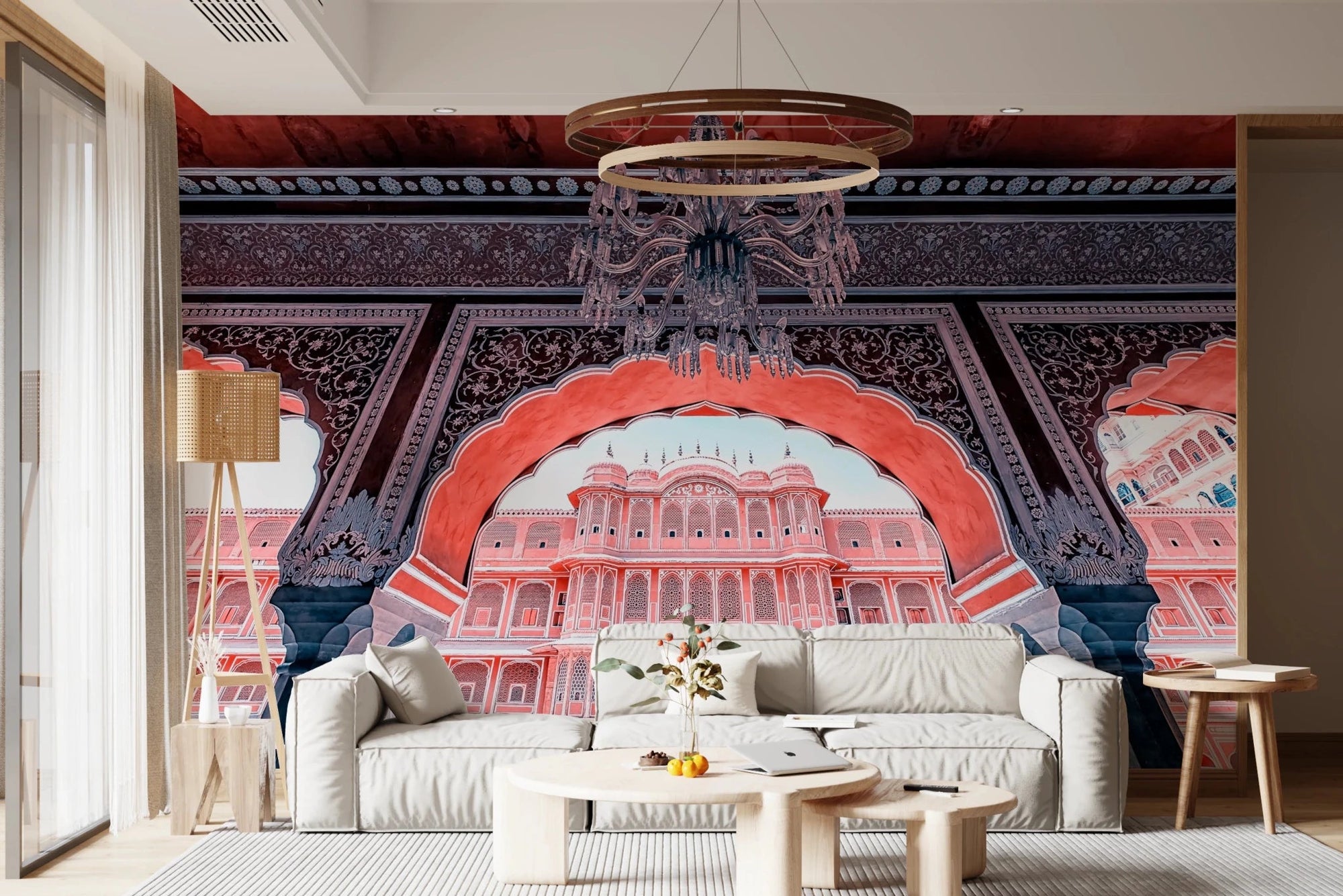 Jaipur Palace View wallpaper mural of a red archway framing a pink palace above a cream sofa and chandelier