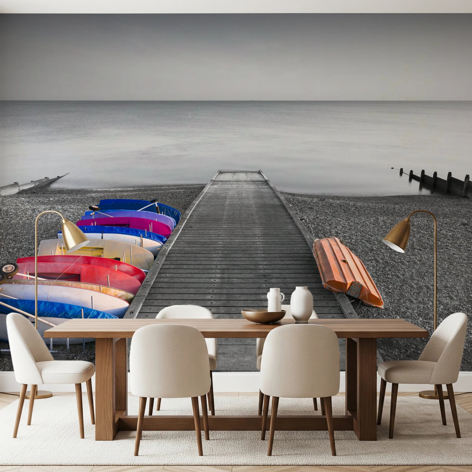 Kayaks on Pier wall mural of colourful boats and a grey jetty behind a walnut dining table with cream chairs