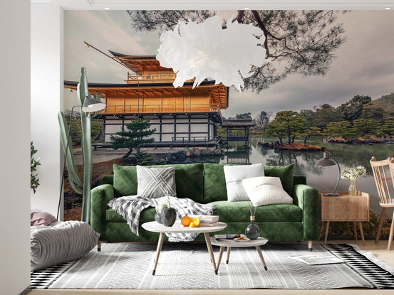Kyoto Serenity wall mural of the golden Kinkaku-ji temple by a pond behind a green velvet sofa