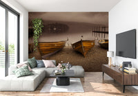 Serene wallpaper featuring wooden rowboats pulled ashore beside a still, sepia-filtered lake.