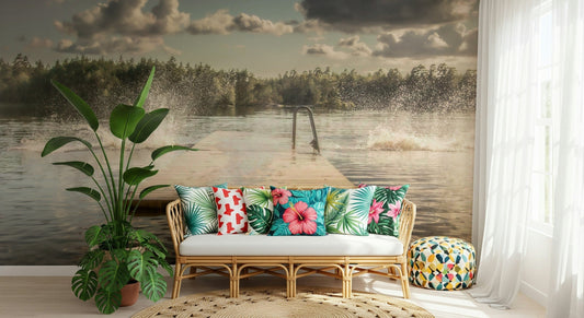 Lake Jump! wallpaper mural of a forest lake jetty behind a rattan sofa with tropical pillows and a tall plant