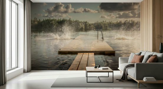 Lake Jump! wallpaper mural of a wooden dock and splashing lake water above a grey sofa in a bright living room