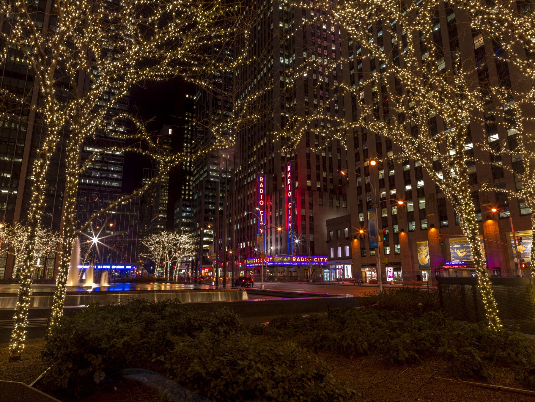 Radio City Night Glow wall mural lights a quiet living room with red marquee shine