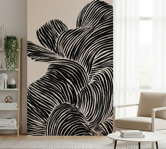 Linear wallpaper mural with flowing black-and-white line waves beside a beige armchair and white bookshelf in a living room