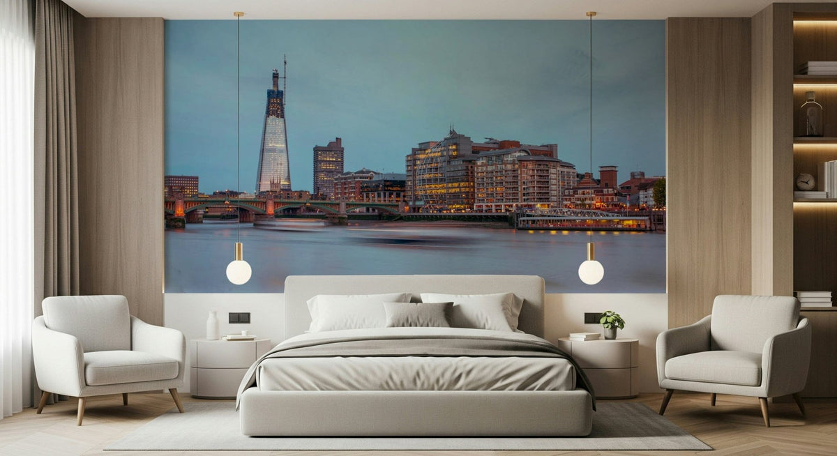 London Luminescence wallpaper mural of The Shard and Thames skyline at dusk behind a grey bed and armchairs in a bedroom