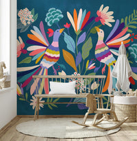 Love Birds mural of colorful peacock birds on deep blue above a wooden crib in a bright nursery