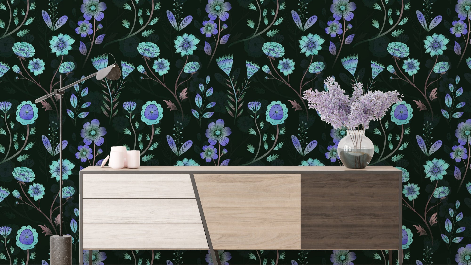 Luminous Floral Whispers Bluish Tones wallpaper behind a wood sideboard with an arc lamp and lilac blooms