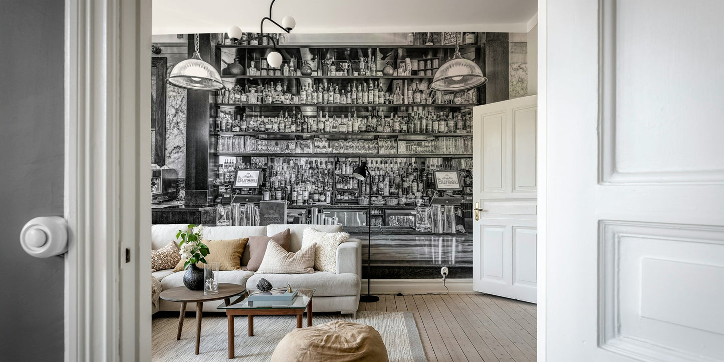 The image shows a full wall with a bar counter and shelves of bottles.

