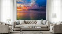 Moody storm clouds wallpaper with orange horizon