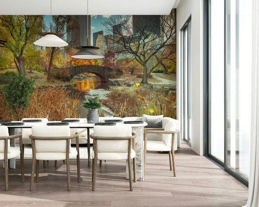 Manhattan's Autumn Embrace wallpaper mural of Central Park in fall behind a marble dining table and cream chairs