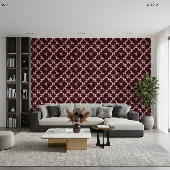 Maroon Lattice wallpaper in burgundy and cream behind a grey sofa with a black bookshelf and marble coffee table in a living room
