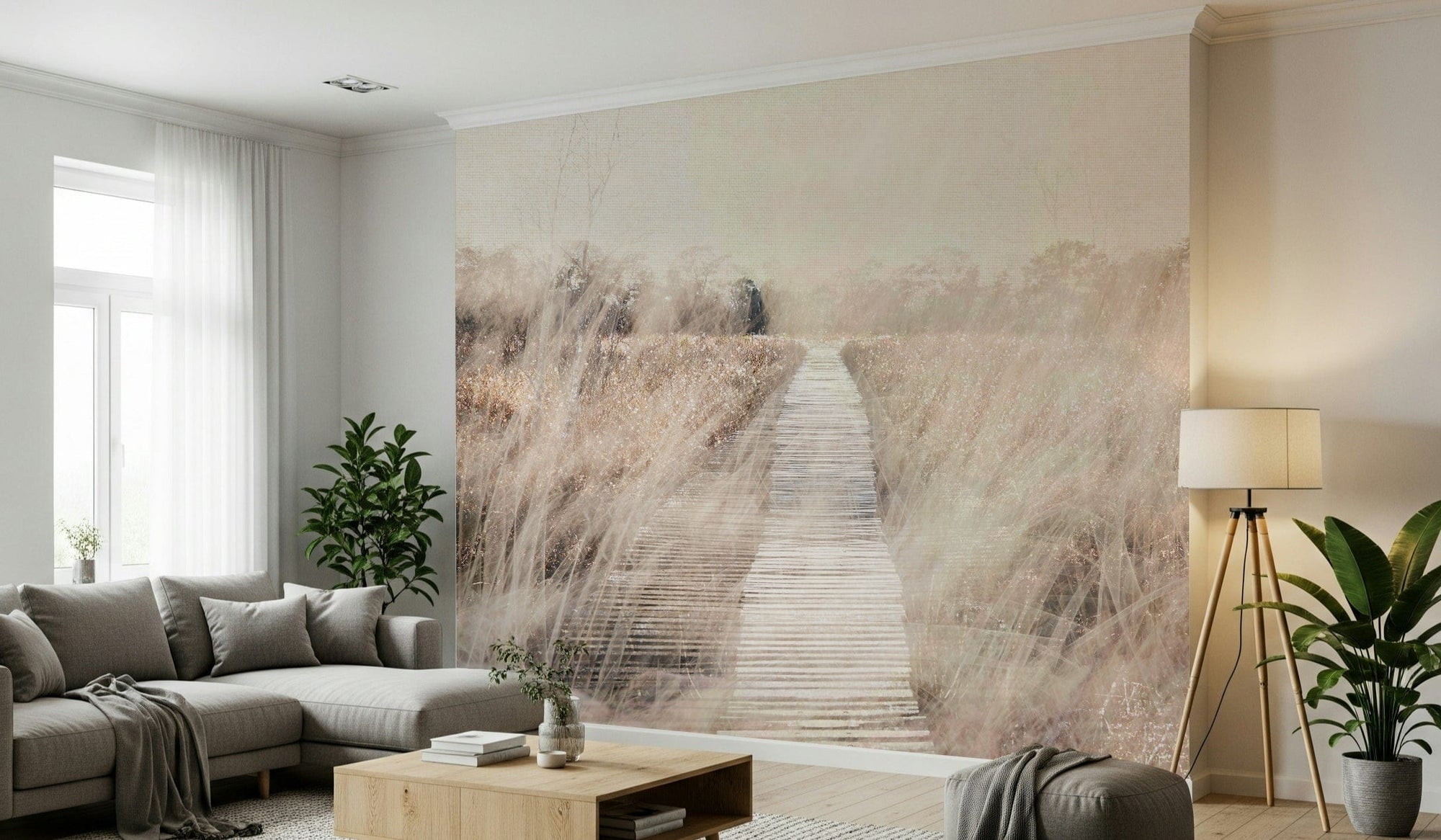 Whispers of the Marsh Path wallpaper mural of a misty boardwalk through beige grasses by a gray sectional sofa