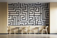 Black maze design on white backdrop
