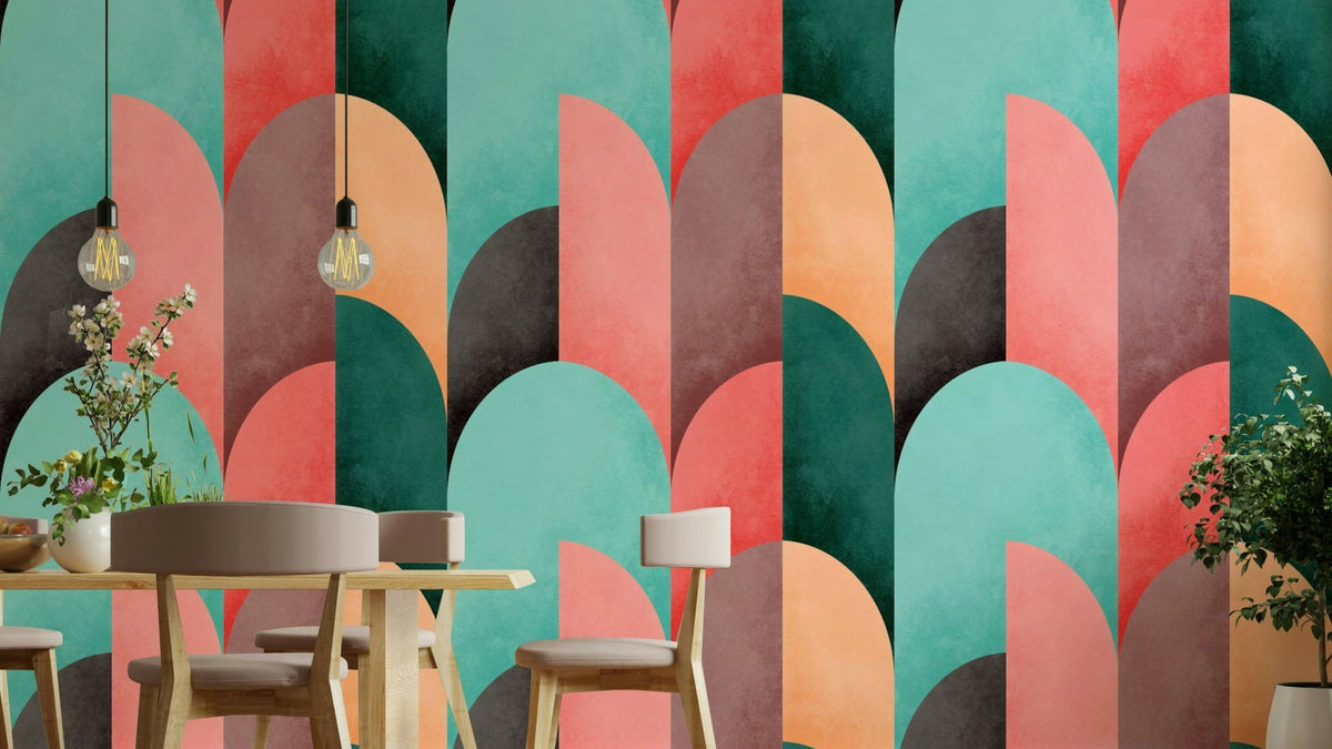 Mid Mod Geometry Sunrise wallpaper mural in teal, coral and orange arches behind a light wood dining table and chairs