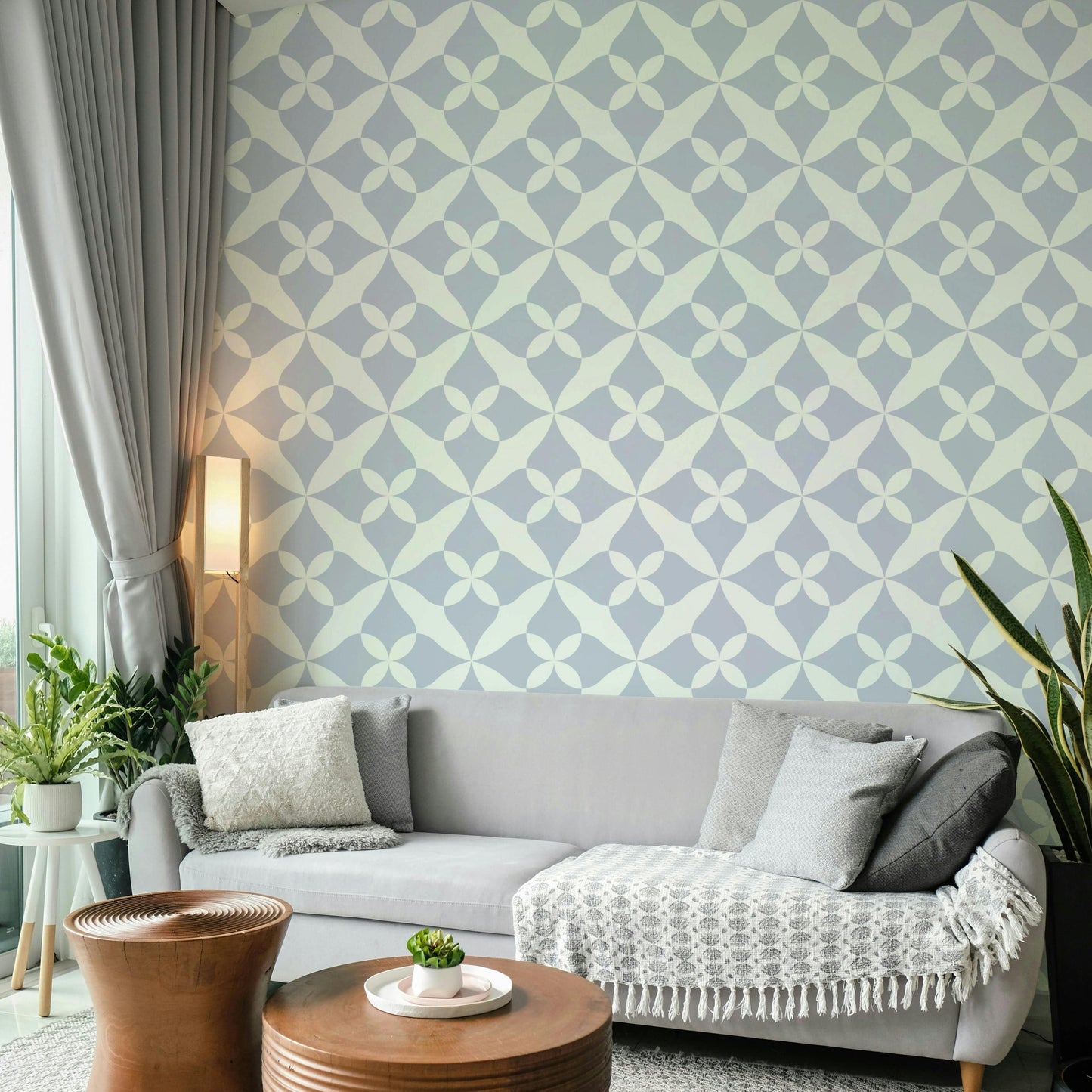 Repeating floral motif wallpaper in dusty blue.