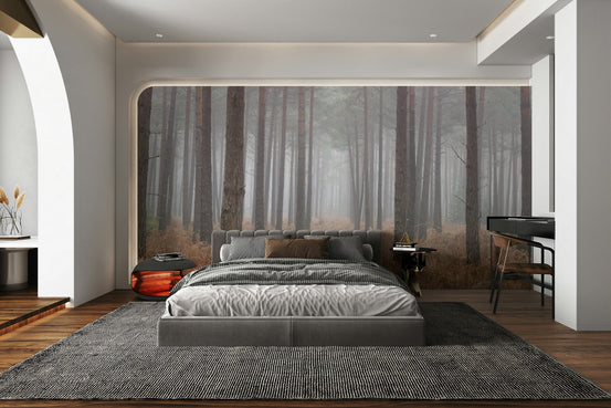 Misty Woodland Escape wallpaper mural of foggy pine trees and rust ferns behind a grey bed in a modern bedroom