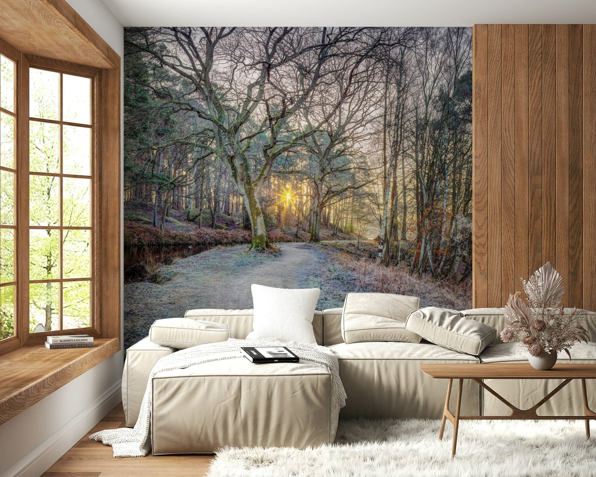 Misty Woodland Glare mural of a frosty forest path and sunburst behind a cream sectional sofa and wood table