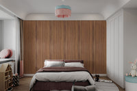 Minimalist bedroom decor with a warm oak wood panel wallpaper headboard.