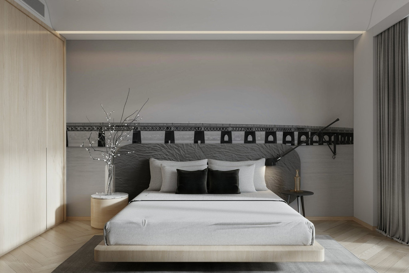 A wall mural of a bridge in a monochrome color scheme.

