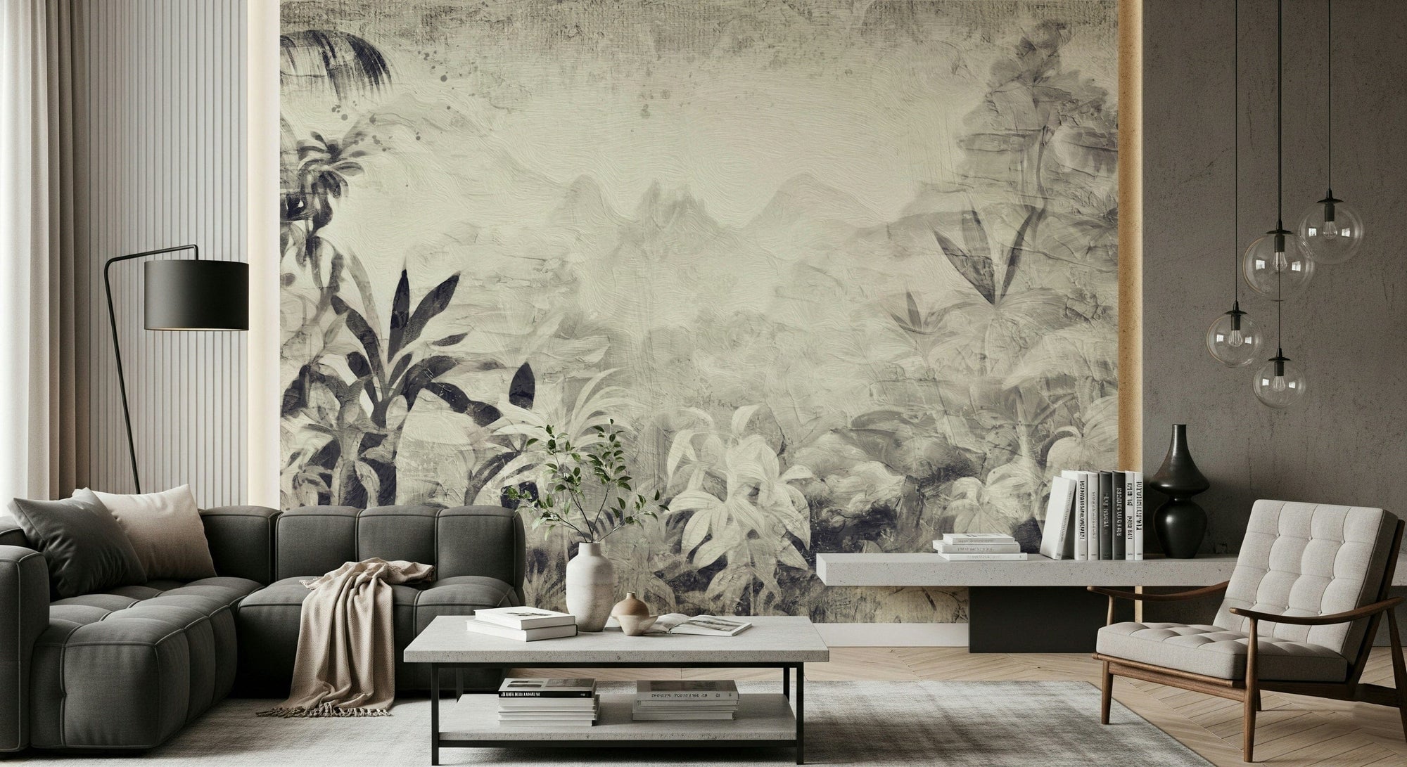 Monochrome Jungle Dream wallpaper mural in grey tropical foliage behind a grey sectional and cream armchair living room
