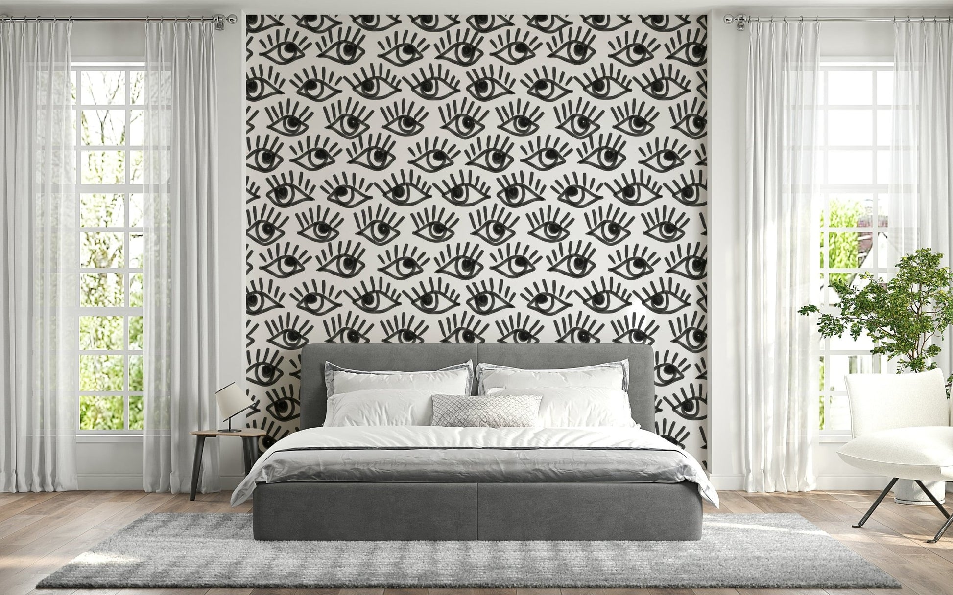 Decorative wall mural with intense staring eyes in grayscale for a dramatic effect.