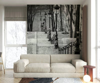 Parisian stairway mural with vintage street lamps and steps.

