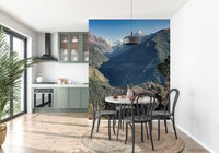 Panoramic mountain vista mural with a quaint hut nestled among lush green hills.