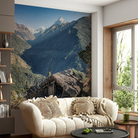 Mountain wilderness wall mural showing a lone hut amid vast green valleys and sharp peaks.