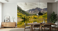 Open-plan living space with fall mountain lake wallpaper, modern art and textiles