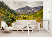 Mountain lake in fall colors wallpaper behind sofa, modern apartment wall decor