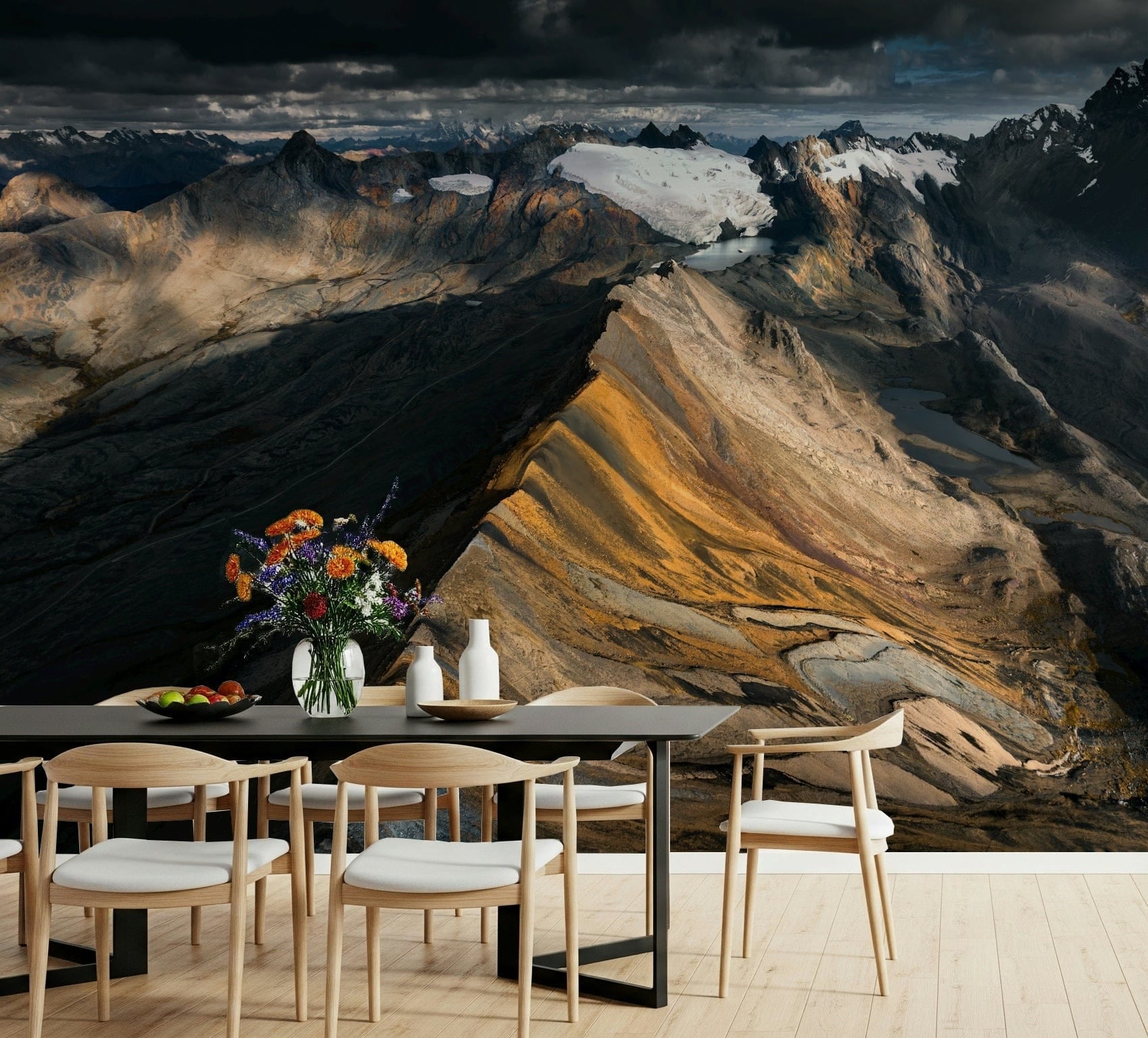 Mountain Ridge Vista wallpaper mural of a golden ridge and glaciers behind a dark dining table with wildflowers