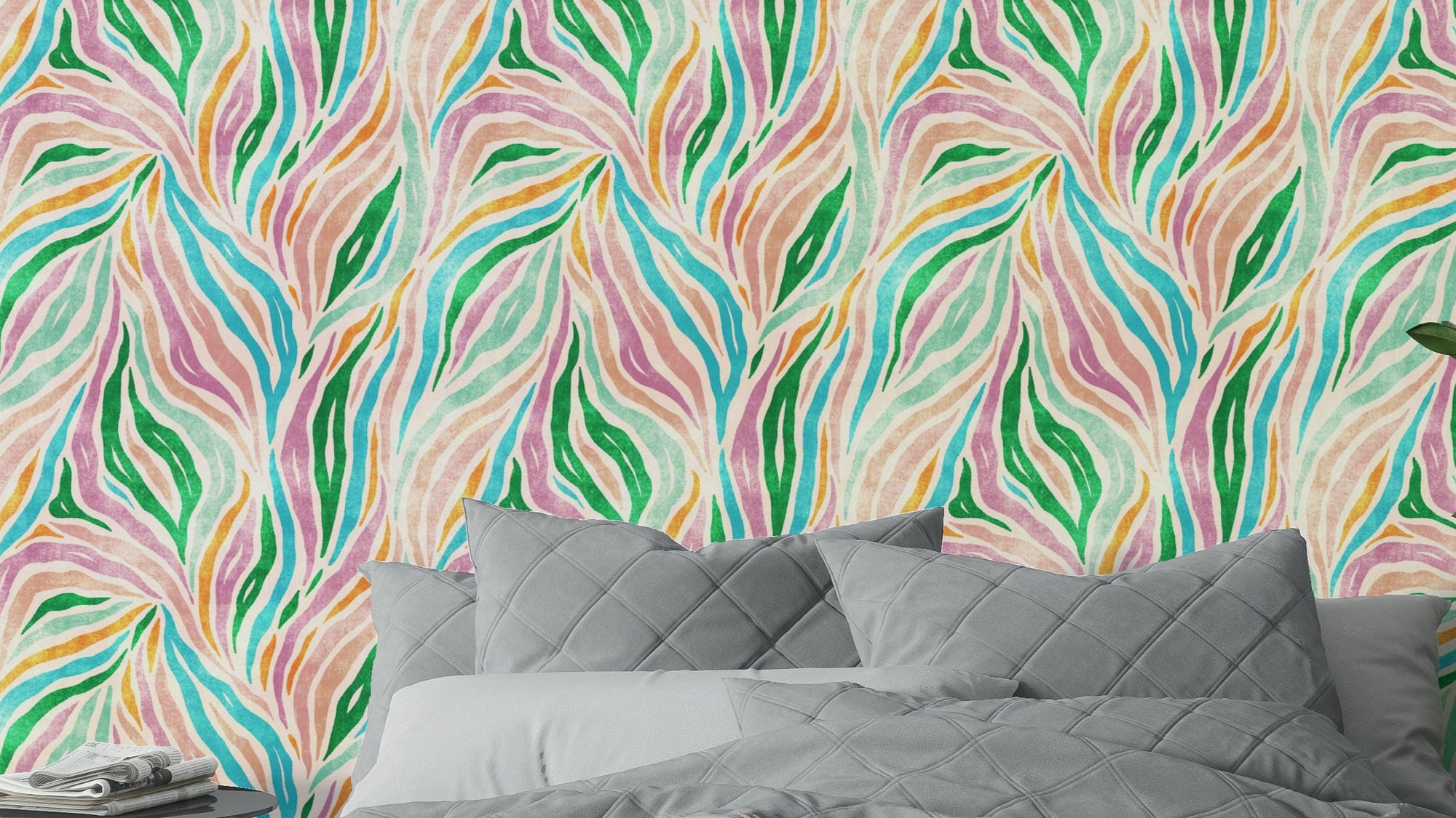 Multicolor Boho Zebra Print wallpaper with pink and green wavy stripes behind a gray quilted bed in a bedroom