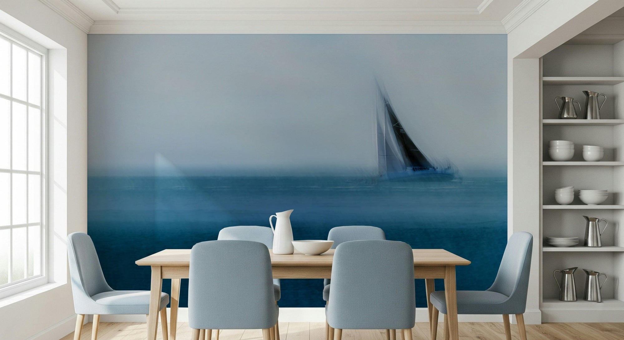 Mystic Sail wallpaper mural of a hazy blue sea and sailboat in a dining room with wood table and blue chairs