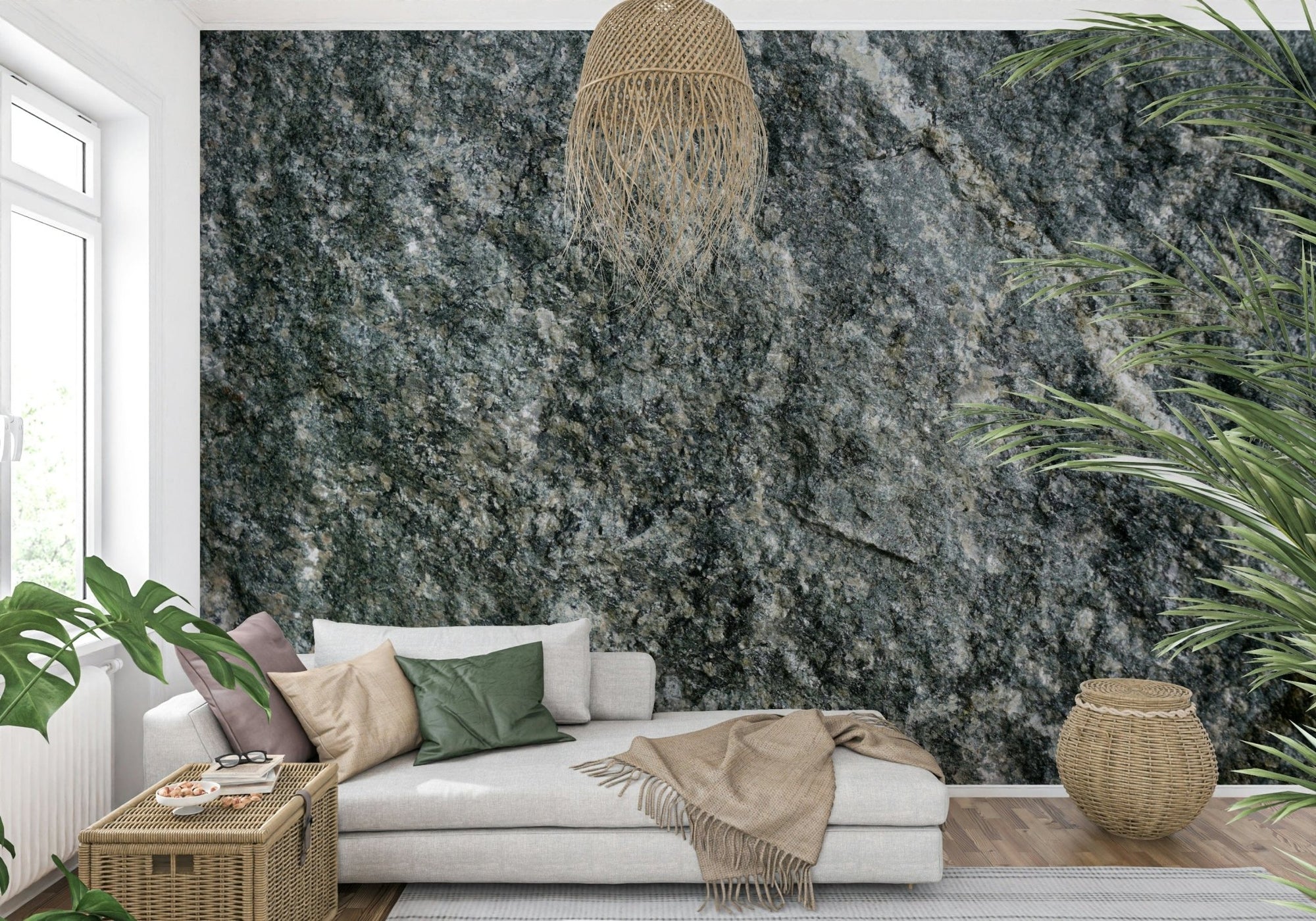 Natural stone finish wallpaper mural in gray-green behind a beige sofa with a rattan pendant in a living room