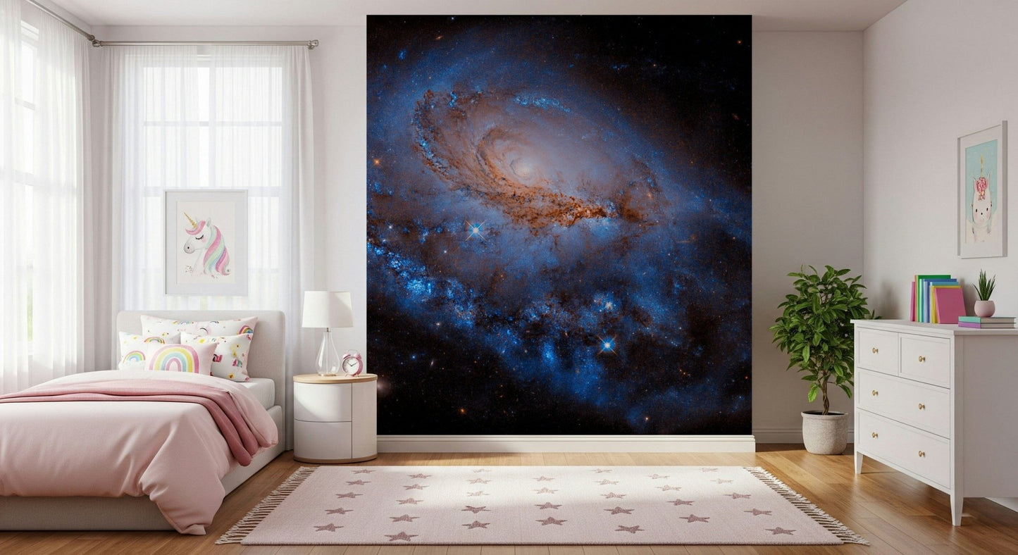Nebula Dreams wall mural of a blue spiral galaxy on black space behind a pink bed with unicorn art in a girls bedroom