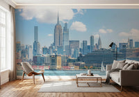An easy to apply and remove mural wallpaper depicts a scenic, wide-angle view of the city skyline from across the water.