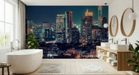 Night cityscape wallpaper behind sofa, deep colour tones and warm light details