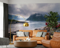 Wall mural depicting a peaceful Norwegian fjord with rocky terrain and fog drifting over mountain tops.