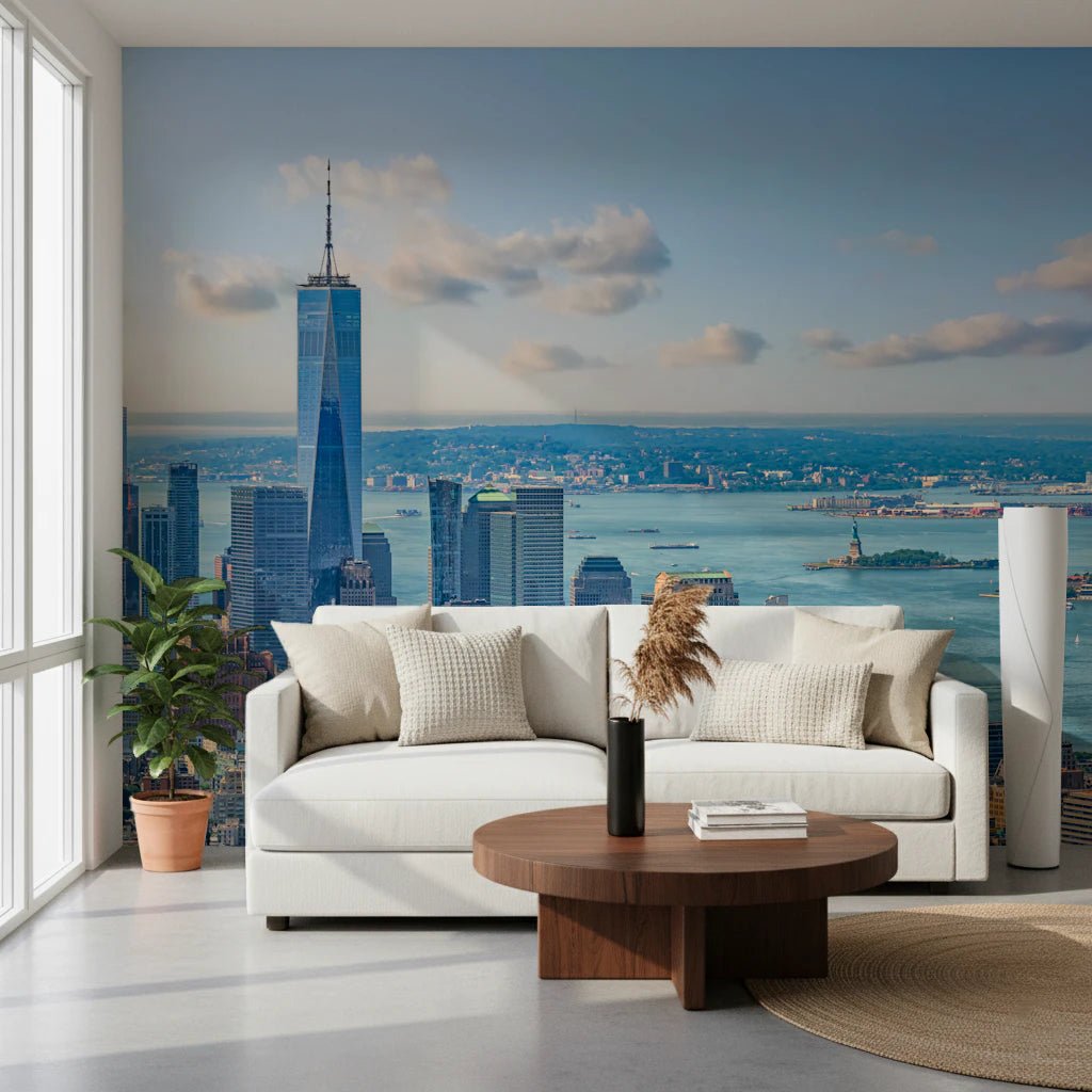 NYC Skyline Majesty wallpaper mural of Manhattan and the harbor behind a white sofa in a bright living room