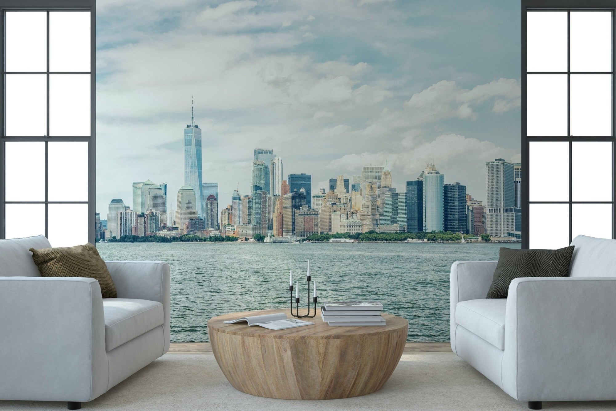 NYC Skyline View wallpaper mural of Lower Manhattan across the harbor between two white armchairs in a living room