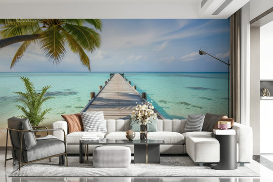 Ocean Pier Dream wallpaper mural of a wooden pier over turquoise sea behind a white sectional in a living room