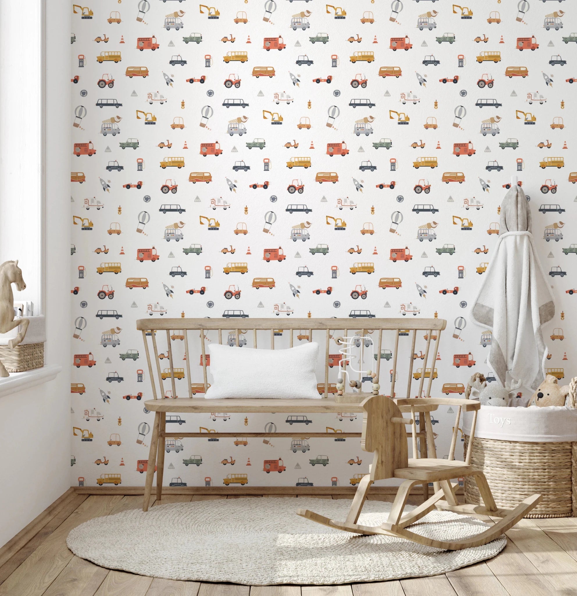 On the Go Vehicles wallpaper mural in a kids room with a wood bench and rocking horse, colorful cars and trucks on white