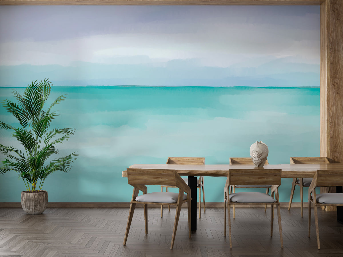 Turquoise Ocean wallpaper mural of a calm watercolor seascape above a long wooden dining table and chairs