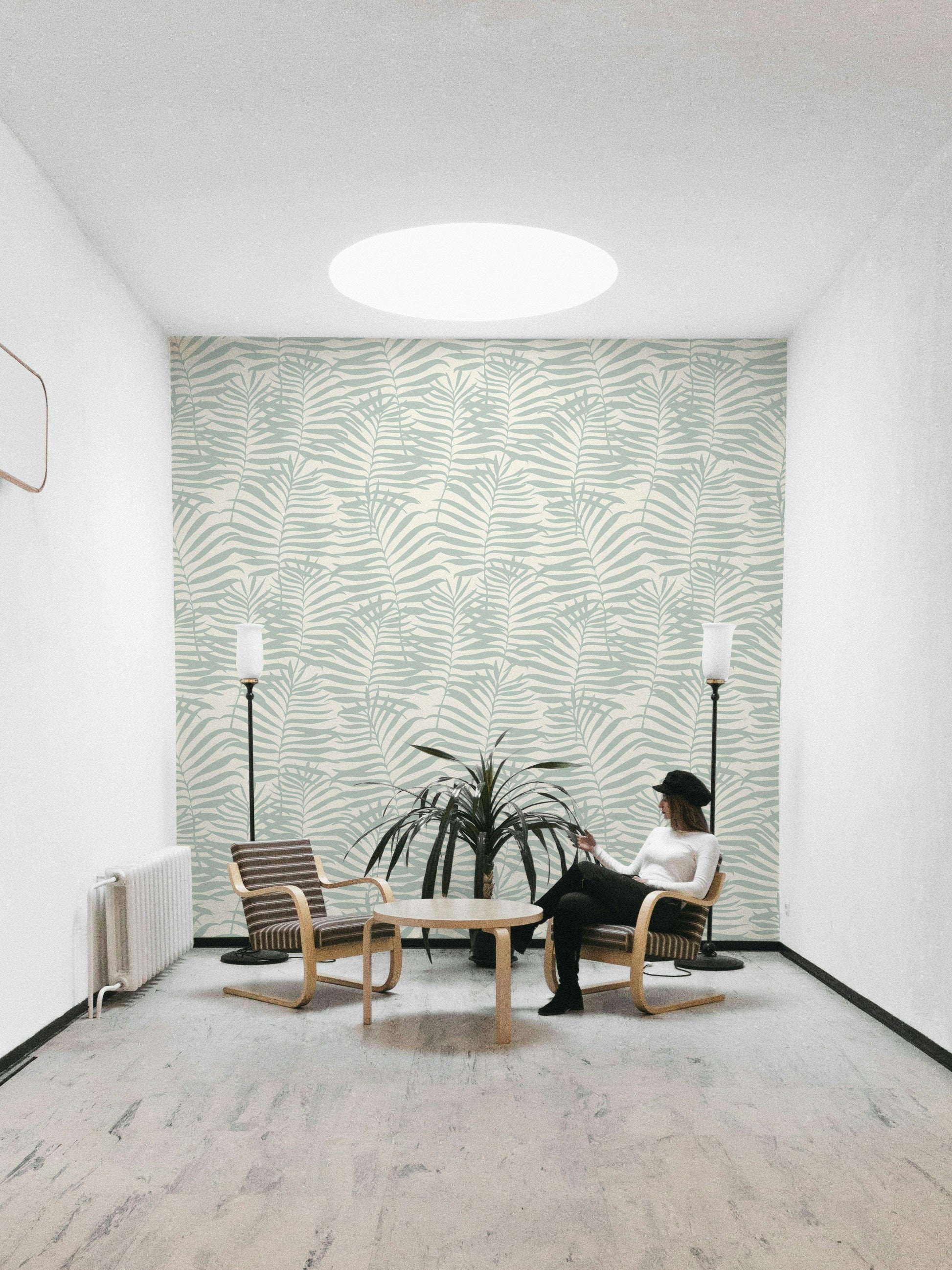 The design is a repeating pattern of large palm leaf silhouettes.
