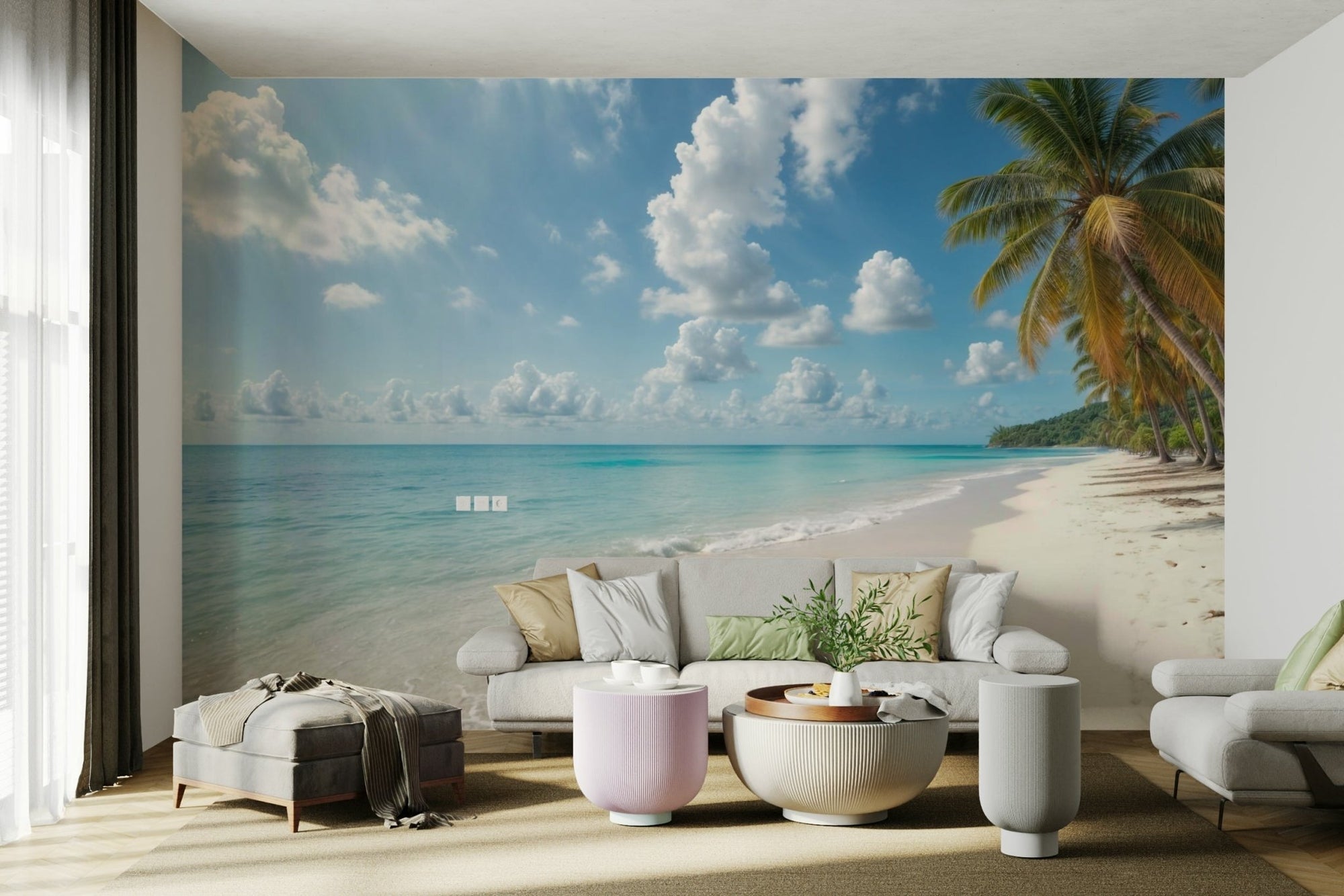 Paradise Shores wallpaper mural of a turquoise palm beach behind a white sofa and pink round tables in a living room